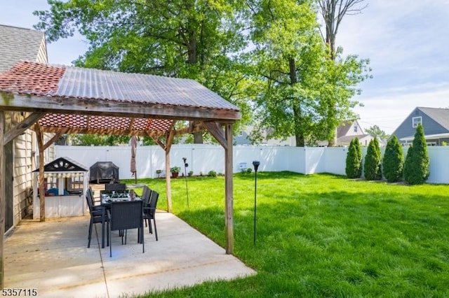 view of yard featuring a gazebo, a patio, and outdoor dining space