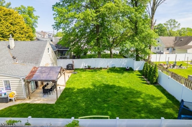 view of yard featuring a patio and a residential view