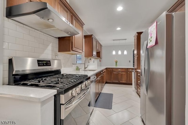 kitchen featuring appliances with stainless steel finishes, wall chimney range hood, brown cabinets, tasteful backsplash, and recessed lighting