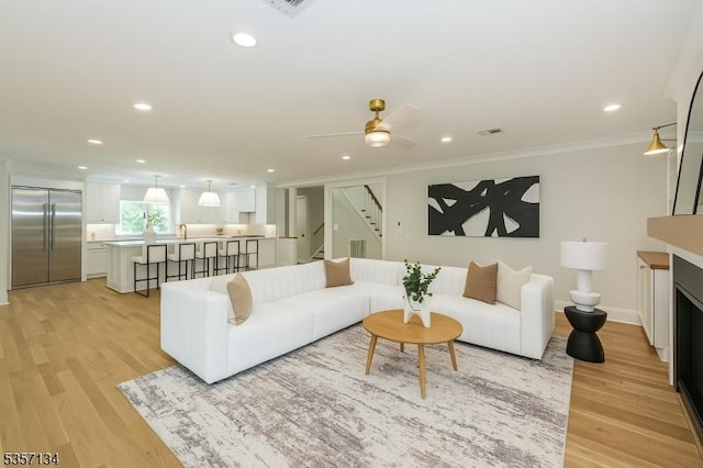157 Meyersville Rd, Chatham Twp, NJ 07928 - living room featuring crown molding, stairway, light wood-style floors, recessed lighting, and a fireplace