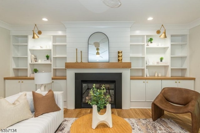 157 Meyersville Rd, Chatham Twp, NJ 07928 - living area featuring light wood-type flooring, a ceiling fan, a large fireplace, and crown molding
