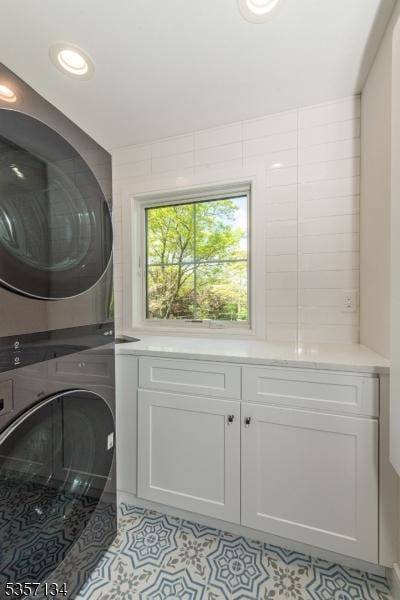 157 Meyersville Rd, Chatham Twp, NJ 07928 - washroom with stacked washer / drying machine, cabinet space, and light tile patterned flooring