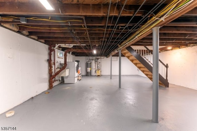 unfinished basement featuring stairway and water heater