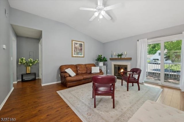 48 Spruce Ct, Bedminster Twp, NJ 07921 - living room with wood finished floors, lofted ceiling, a glass covered fireplace, a ceiling fan, and baseboards