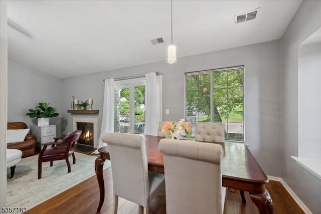 48 Spruce Ct, Bedminster Twp, NJ 07921 - dining room featuring dark wood-type flooring, a fireplace with flush hearth, and baseboards