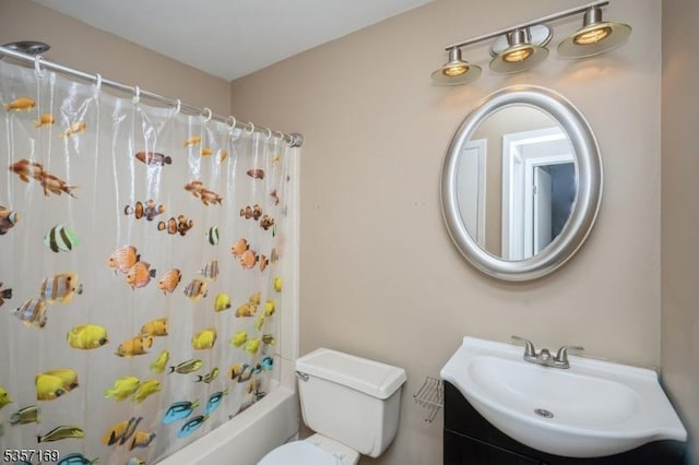 bathroom featuring toilet, shower / bathtub combination with curtain, and vanity