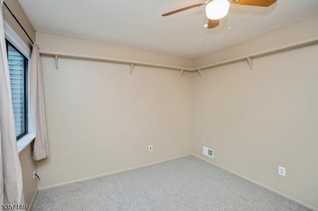 walk in closet featuring a ceiling fan and carpet floors