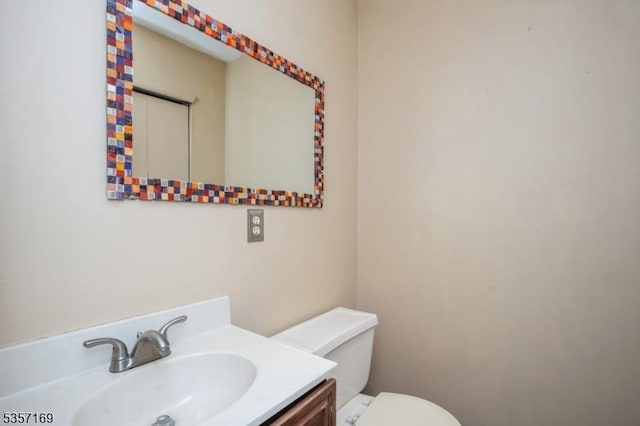 bathroom with toilet and vanity