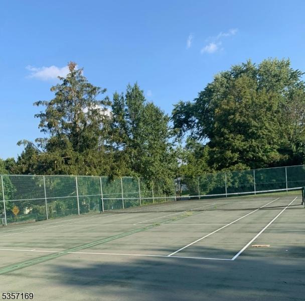view of tennis court featuring fence