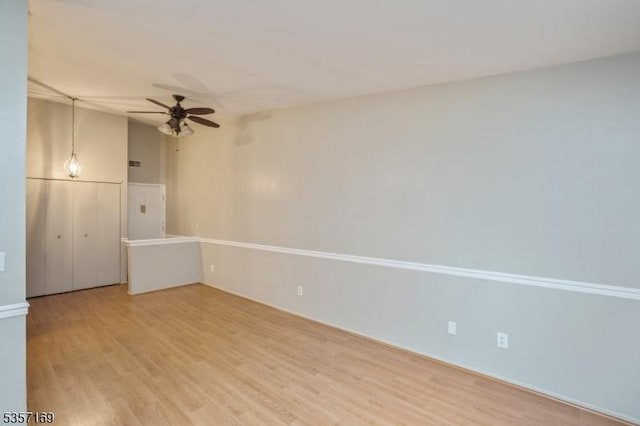 unfurnished room with a ceiling fan and light wood-style floors