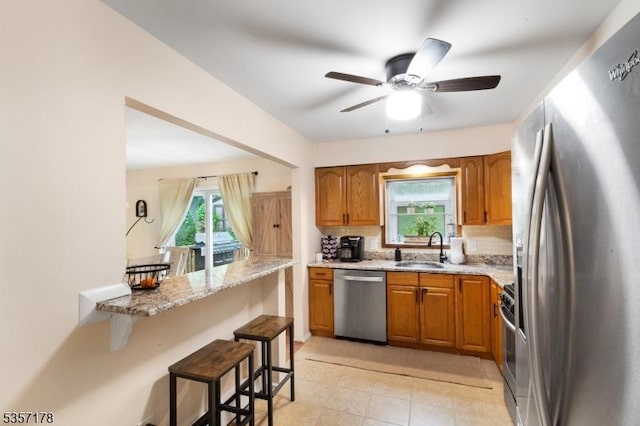 642 Succasunna Rd, Mount Arlington Boro, NJ 07850 - kitchen with appliances with stainless steel finishes, a sink, brown cabinets, and a breakfast bar