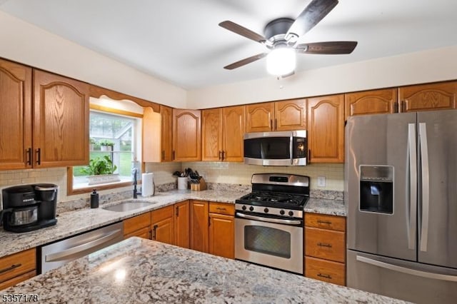 642 Succasunna Rd, Mount Arlington Boro, NJ 07850 - kitchen with appliances with stainless steel finishes, a sink, brown cabinets, and light stone counters