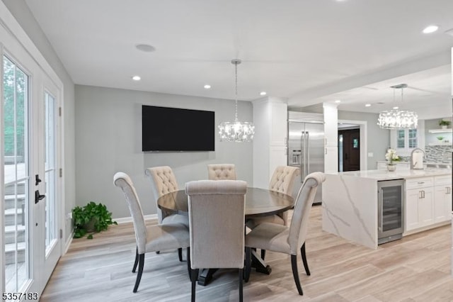 276 River Dr, River Vale Twp, NJ 07675 - dining area featuring beverage cooler, a chandelier, healthy amount of natural light, light wood finished floors, and recessed lighting