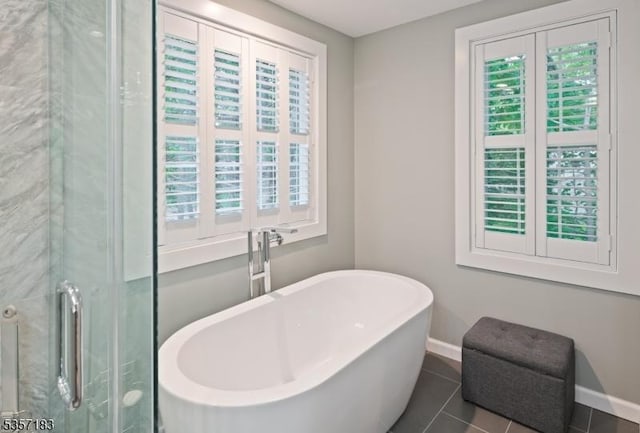 276 River Dr, River Vale Twp, NJ 07675 - bathroom with baseboards, a freestanding bath, tile patterned flooring, and a shower with shower door