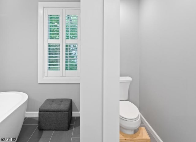 276 River Dr, River Vale Twp, NJ 07675 - bathroom featuring toilet, baseboards, a freestanding bath, and tile patterned flooring