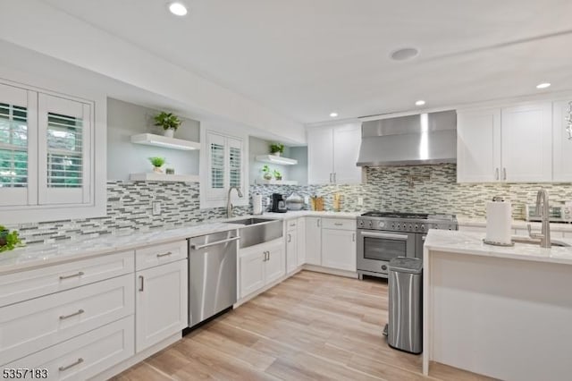 276 River Dr, River Vale Twp, NJ 07675 - kitchen featuring wall chimney range hood, appliances with stainless steel finishes, a sink, open shelves, and tasteful backsplash