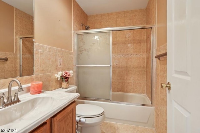 47 Nostrand Rd, Hillsborough Twp, NJ 08844 - bathroom featuring tile walls, vanity, enclosed tub / shower combo, toilet, and tile patterned floors
