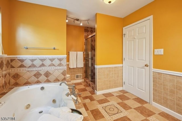 47 Nostrand Rd, Hillsborough Twp, NJ 08844 - bathroom with tile walls, a wainscoted wall, a stall shower, and a jetted tub