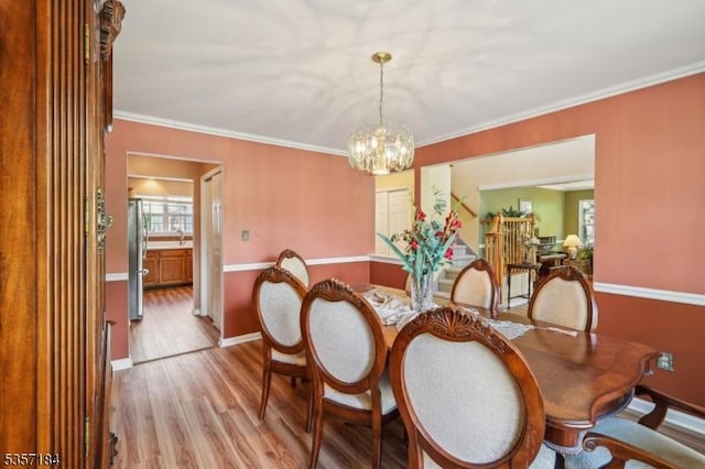47 Nostrand Rd, Hillsborough Twp, NJ 08844 - dining area featuring light wood-style floors, a chandelier, healthy amount of natural light, baseboards, and ornamental molding