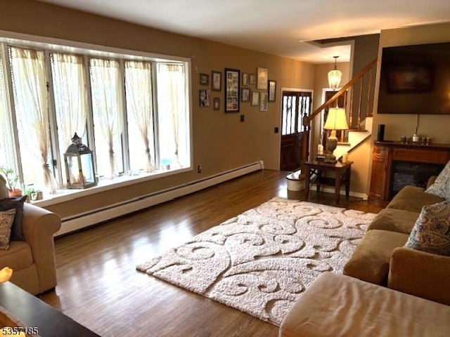 32 Northgate, Wanaque Boro, NJ 07465 - living room featuring a baseboard radiator, wood finished floors, stairs, and baseboards