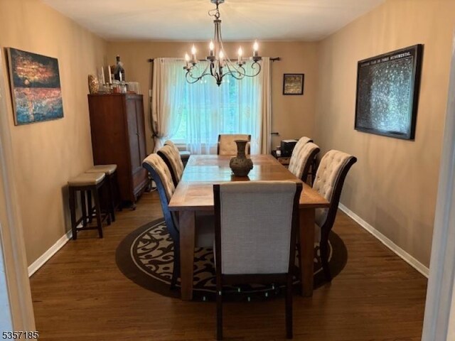 32 Northgate, Wanaque Boro, NJ 07465 - dining room with a chandelier, wood finished floors, and baseboards