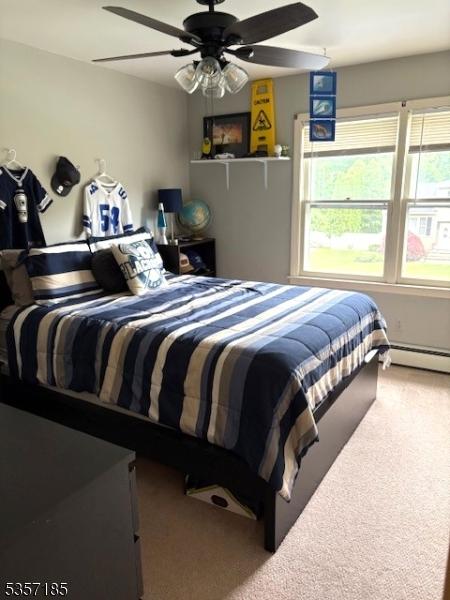 32 Northgate, Wanaque Boro, NJ 07465 - carpeted bedroom with multiple windows, baseboard heating, and a ceiling fan