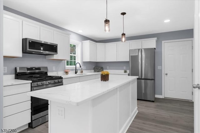 56 Anthony Rd, Lebanon Twp, NJ 08826 - kitchen with appliances with stainless steel finishes, a sink, white cabinets, a kitchen island, and wood finished floors