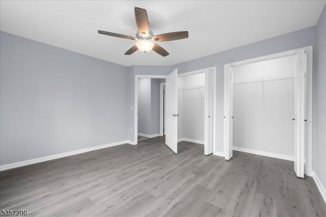 56 Anthony Rd, Lebanon Twp, NJ 08826 - unfurnished bedroom with two closets, light wood-type flooring, baseboards, and a ceiling fan