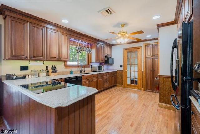 125 Flanders-Drakestown Rd, Mount Olive Twp, NJ 07836 - kitchen with black appliances, a peninsula, light wood-style floors, a wainscoted wall, and a sink