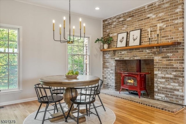 156 Fox Chase Rd, Chester Twp, NJ 07930 - dining space featuring a wood stove, healthy amount of natural light, wood finished floors, and a chandelier