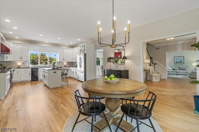 156 Fox Chase Rd, Chester Twp, NJ 07930 - dining space with light wood-type flooring, recessed lighting, stairs, and a chandelier