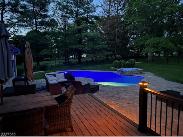 view of pool featuring a deck, a patio area, and a pool with connected hot tub