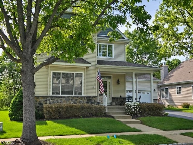 view of front facade with a front lawn, stone siding, and a porch