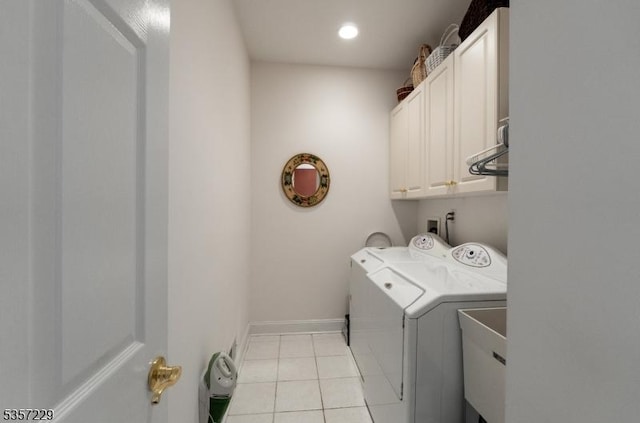 washroom featuring washer and dryer, cabinet space, light tile patterned floors, baseboards, and recessed lighting