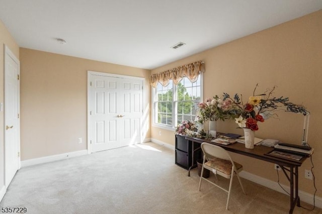 carpeted home office with baseboards