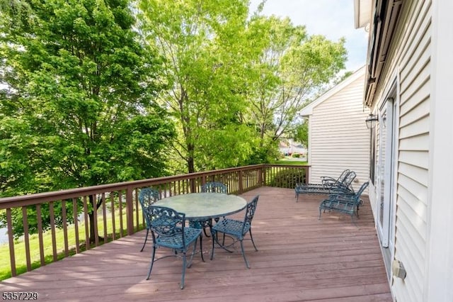 wooden deck featuring outdoor dining space