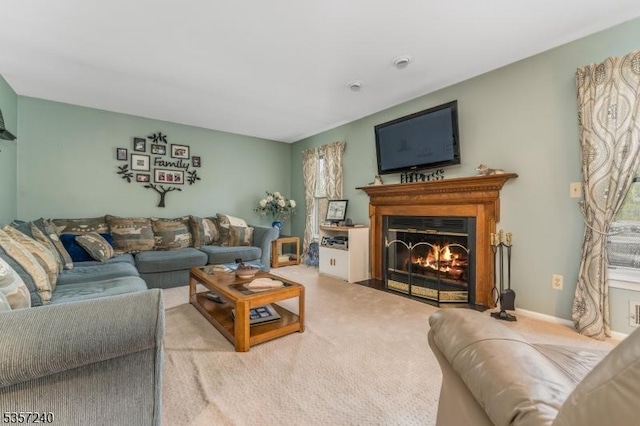 living room featuring carpet flooring and a fireplace with flush hearth