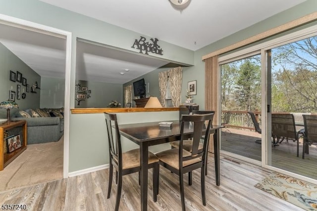 dining area with wood finished floors and baseboards