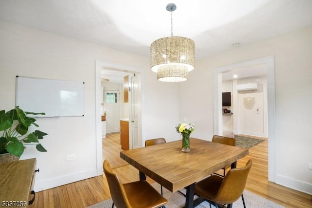 955 Stillwater Rd, Stillwater Twp, NJ 07860 - dining room featuring light wood-type flooring, a wall mounted air conditioner, baseboards, and a chandelier