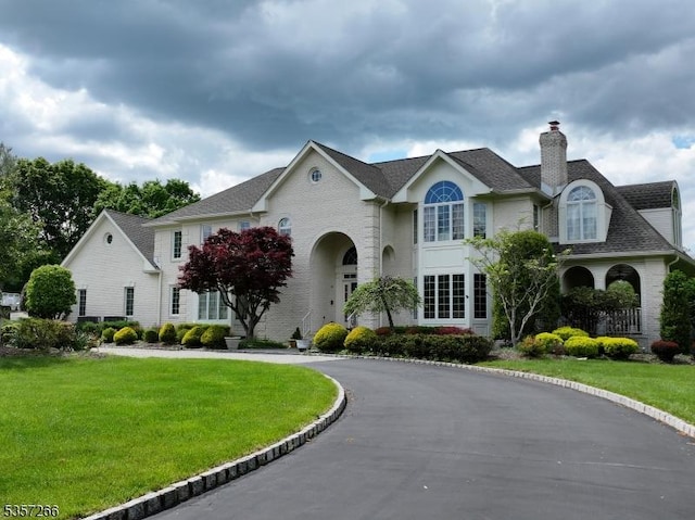 533 Horizon Way, Branchburg Twp, NJ 08853 - french country inspired facade with a chimney, a front yard, and a shingled roof