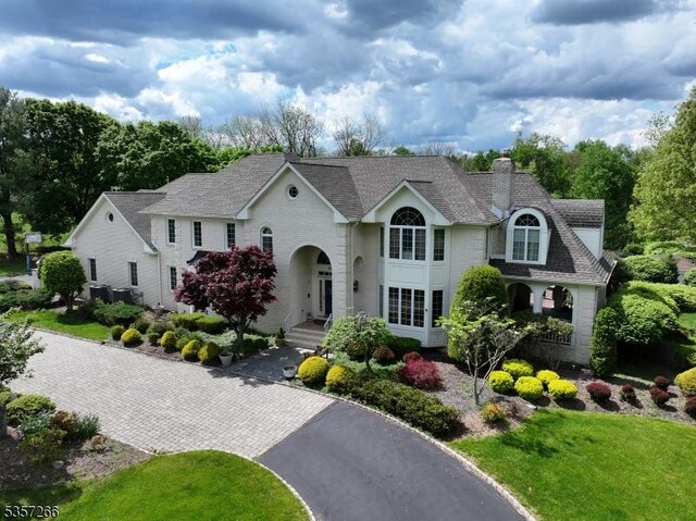 533 Horizon Way, Branchburg Twp, NJ 08853 - view of front of property featuring a chimney, roof with shingles, and central AC unit