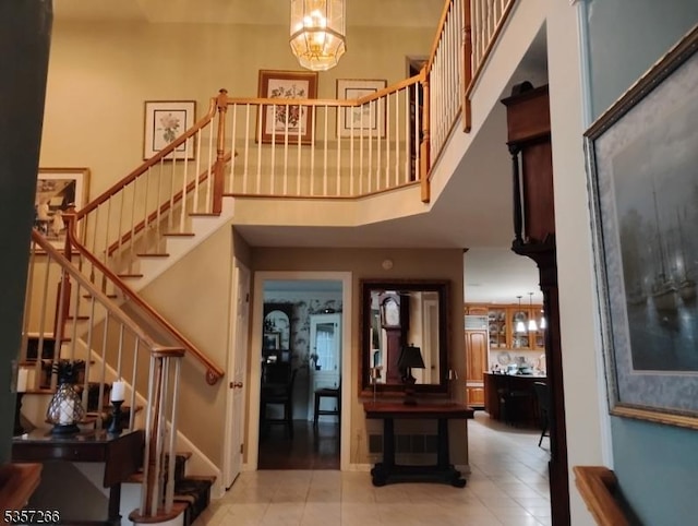533 Horizon Way, Branchburg Twp, NJ 08853 - tiled entrance foyer with a towering ceiling, stairway, and a chandelier