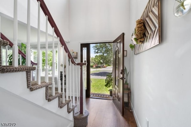 4 Cickener Rd, Hillsborough Twp, NJ 08844 - foyer entrance with healthy amount of natural light, stairway, a towering ceiling, and hardwood / wood-style floors