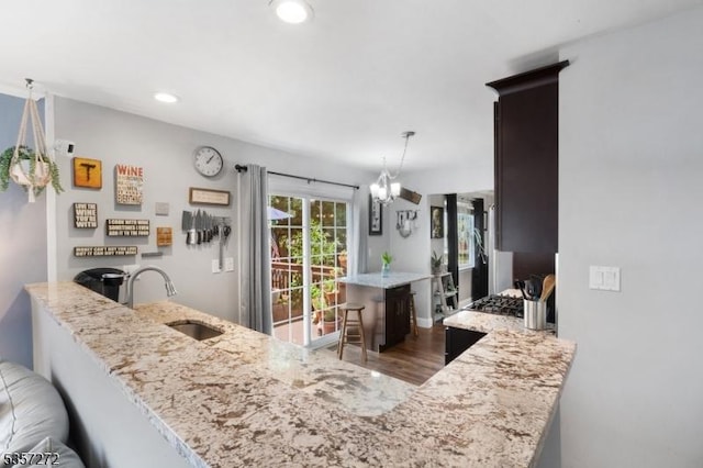 4 Cickener Rd, Hillsborough Twp, NJ 08844 - kitchen featuring light stone countertops, a chandelier, a peninsula, recessed lighting, and wood finished floors
