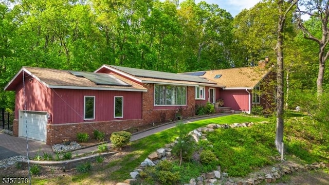 8 Reger Rd, Chester Twp, NJ 07836 - single story home featuring brick siding, a garage, solar panels, a chimney, and a shingled roof