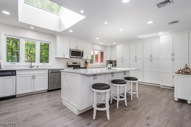 8 Reger Rd, Chester Twp, NJ 07836 - kitchen featuring appliances with stainless steel finishes, a sink, white cabinetry, decorative backsplash, and recessed lighting