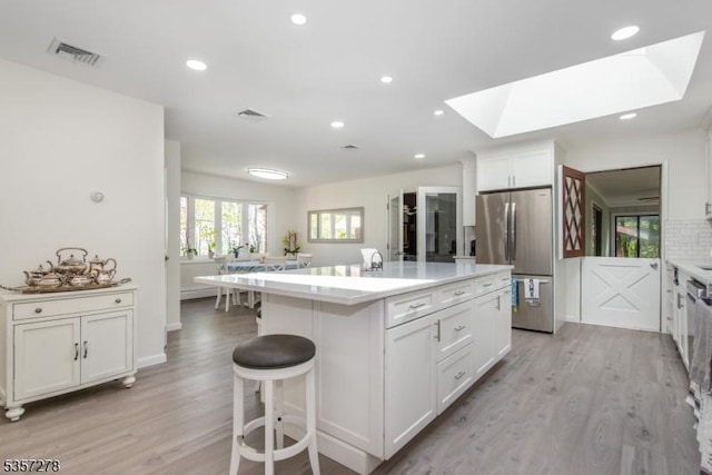 8 Reger Rd, Chester Twp, NJ 07836 - kitchen with freestanding refrigerator, light wood finished floors, light countertops, white cabinets, and recessed lighting