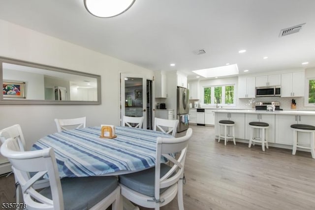 8 Reger Rd, Chester Twp, NJ 07836 - dining area featuring light wood-style flooring, recessed lighting, and a skylight