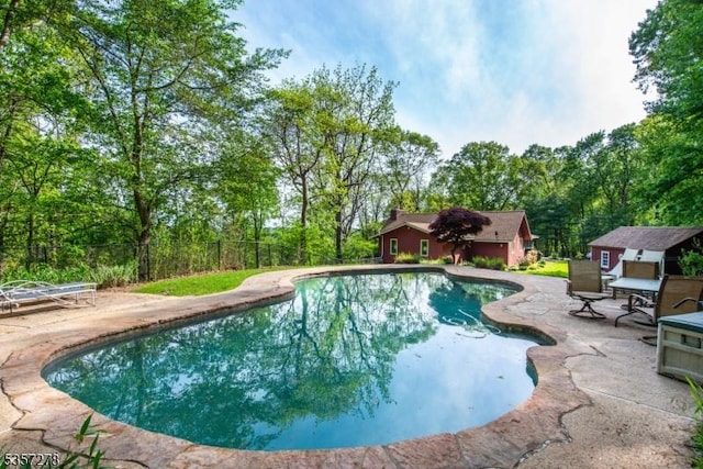 8 Reger Rd, Chester Twp, NJ 07836 - outdoor pool with a patio area, fence, and an outbuilding