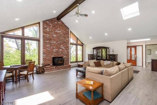 8 Reger Rd, Chester Twp, NJ 07836 - living room featuring high vaulted ceiling, plenty of natural light, light wood finished floors, beamed ceiling, and a wood stove